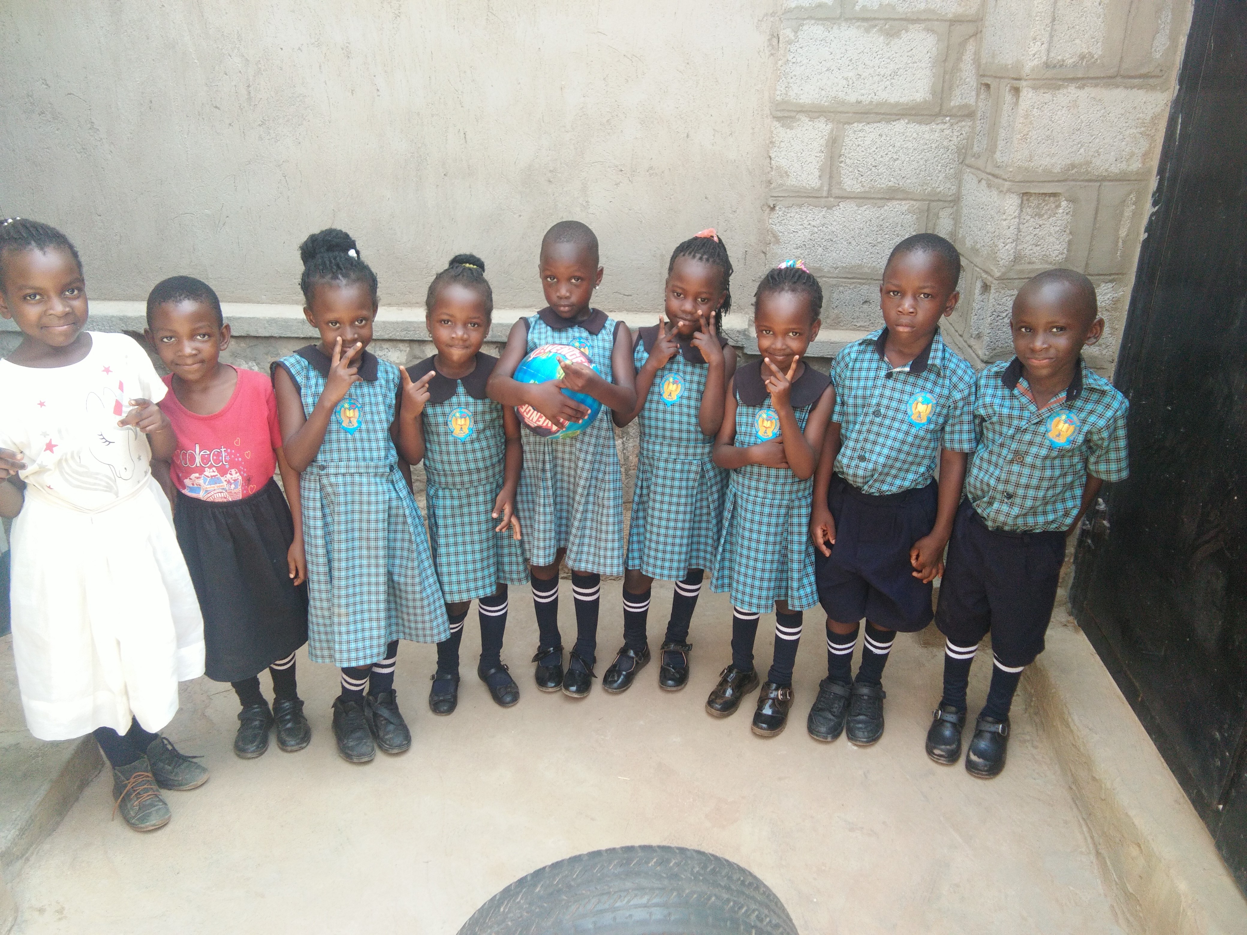 Children receiving school supplies from LYF Uganda